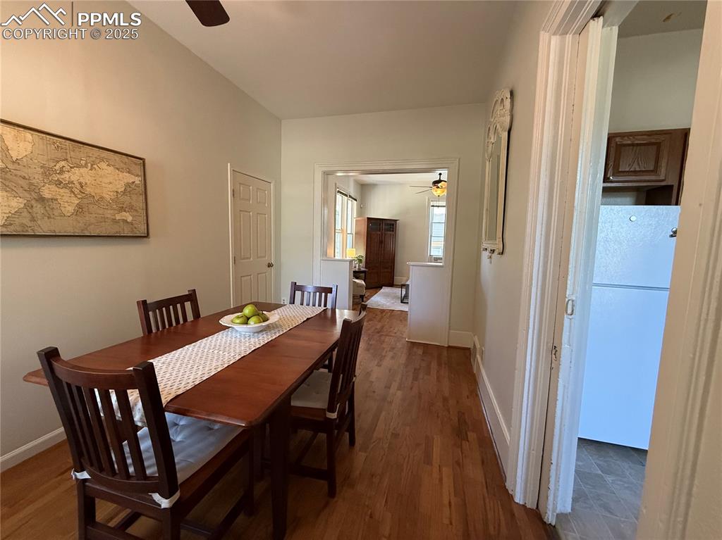 Image 11 of 41: Dining area featuring wood finished floors, ceiling fan, and baseboards