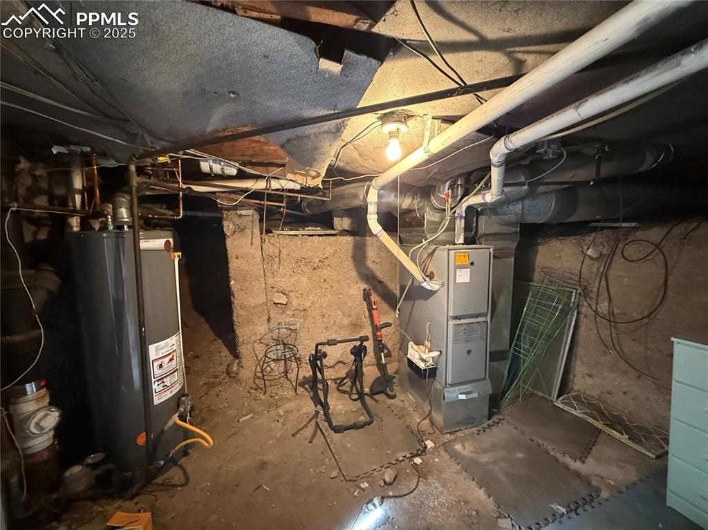 Image 43 of 44: Utilities featuring water heater & furnace. In the basement accessible by t