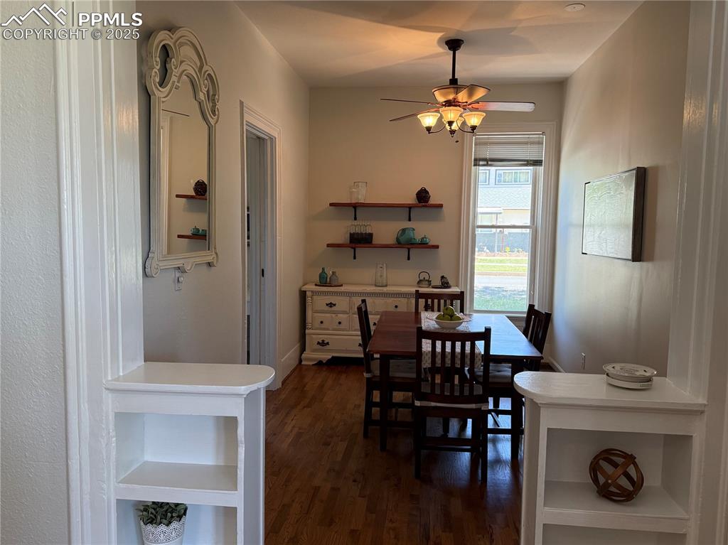 Image 44 of 44: Dining room with dark wood-style flooring and ceiling fan