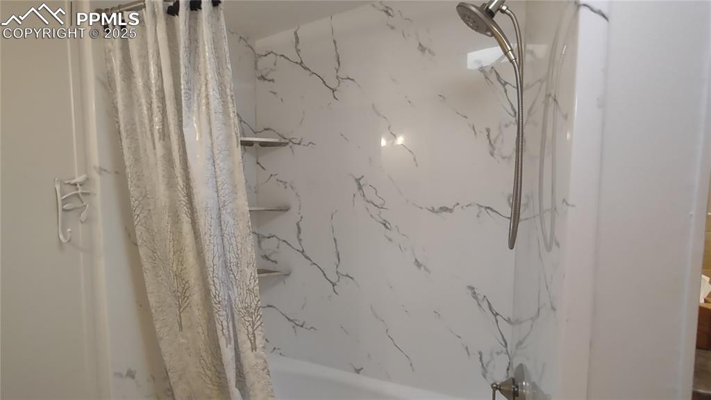 Image 21 of 42: Tub/shower in primary bath remodeled in 2024.