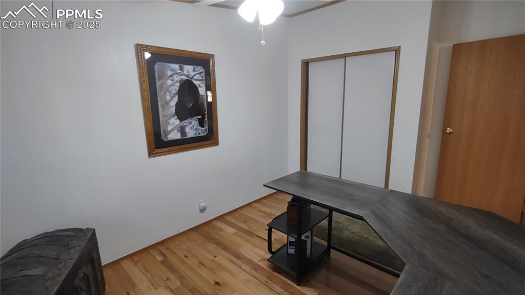 Image 24 of 42: Oak flooring and newer paint in guest bedroom/office.