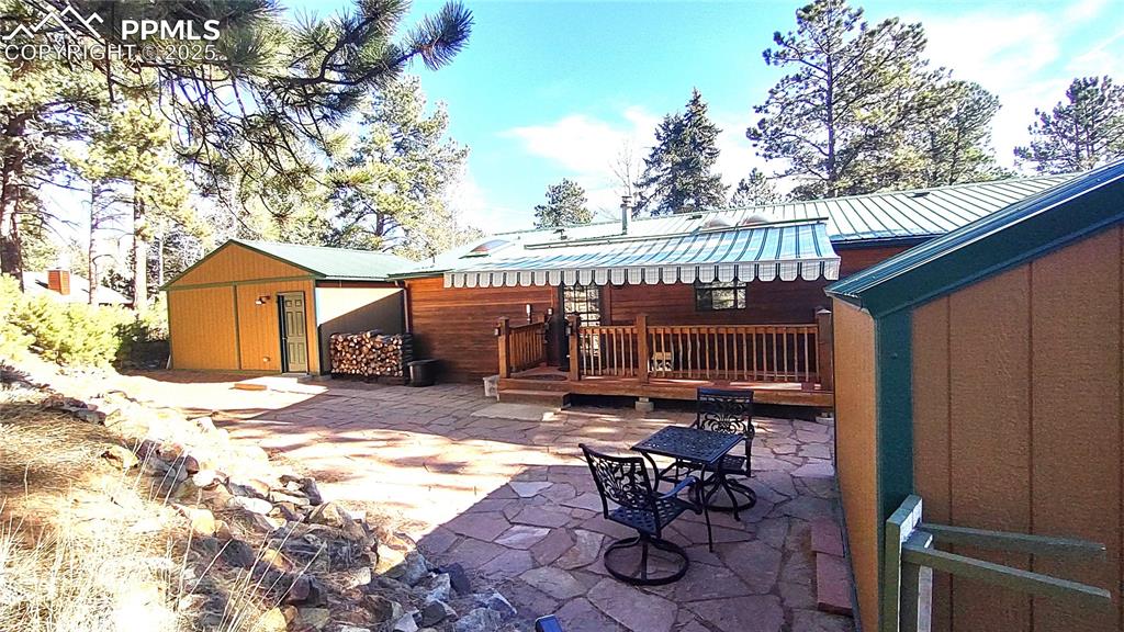 Image 30 of 42: Large flagstone patio accommodates all kinds of outdoor furniture and even 