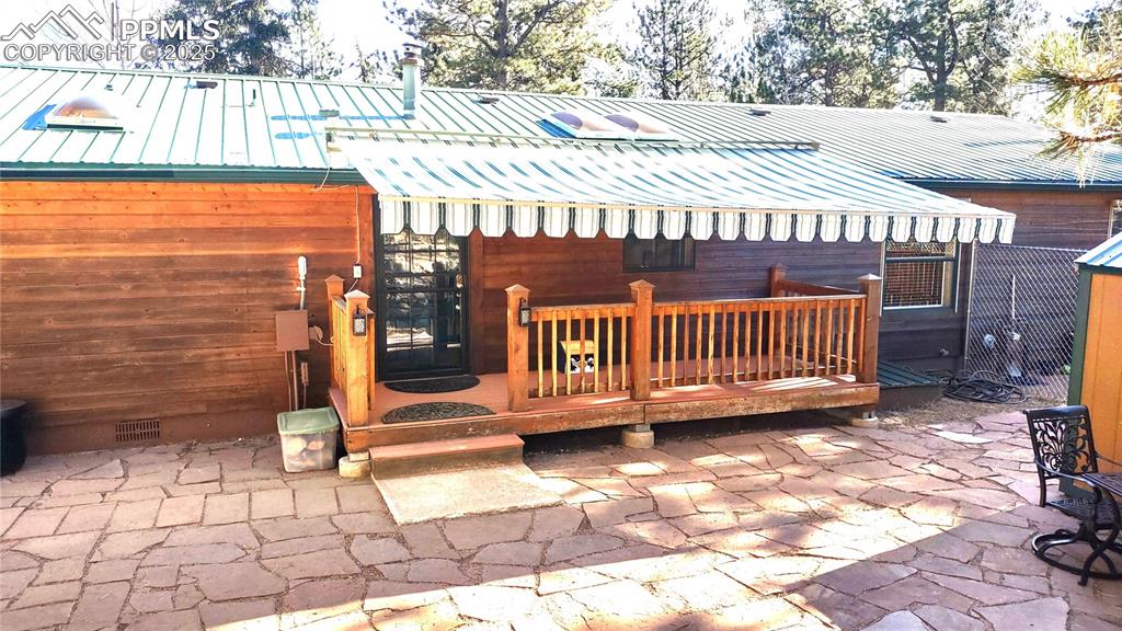 Image 31 of 42: Trex-type deck with retractable awning provides shade in summer while enjoy