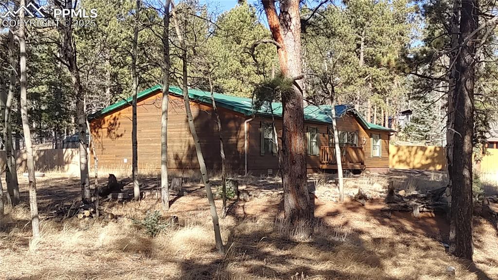 Image 33 of 42: Side view shows privacy fence for dog run behind the house & new privacy fe