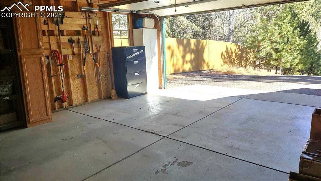 Image 38 of 42: Looking out of garage where you can see the new privacy fence on north side