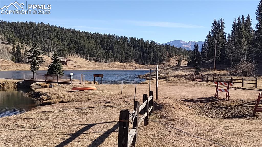 Image 40 of 42: Burgess Lake boat dock and view of Pikes Peak.