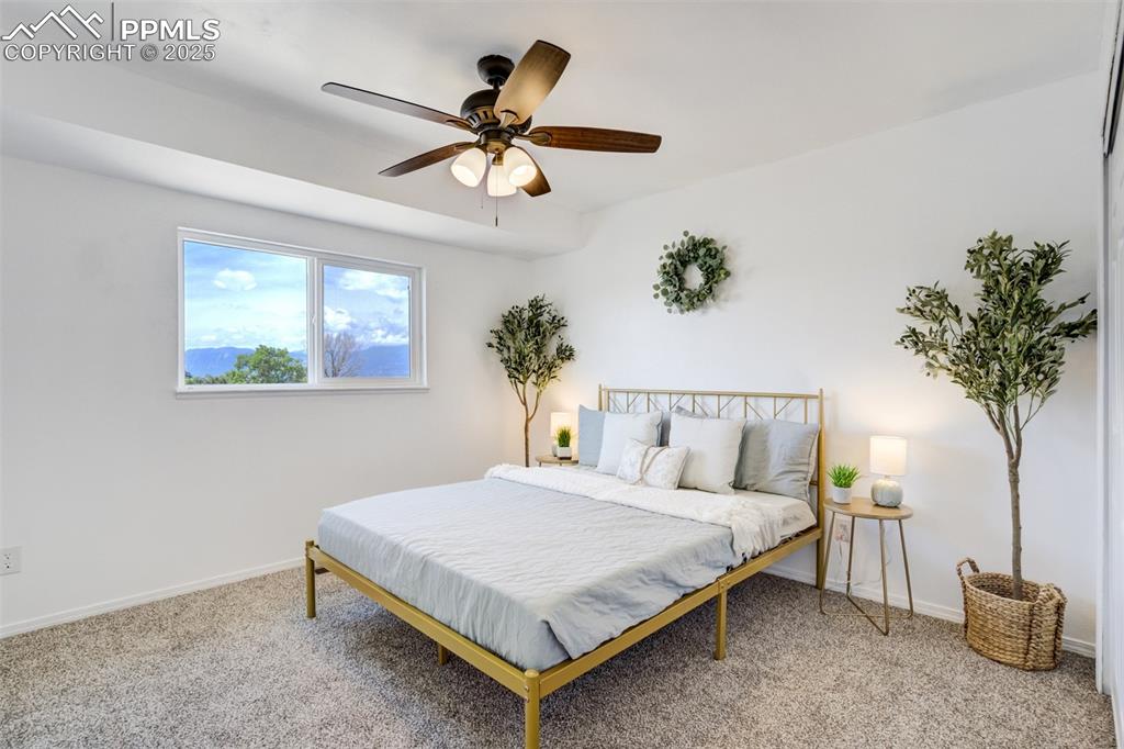 Image 13 of 33: Primary bedroom with backyard and mountain views!!
