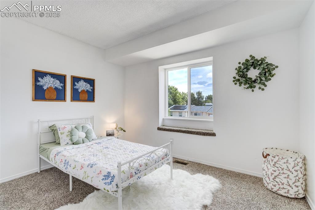 Image 17 of 33: Upper Level Bedroom 2 with front yard views