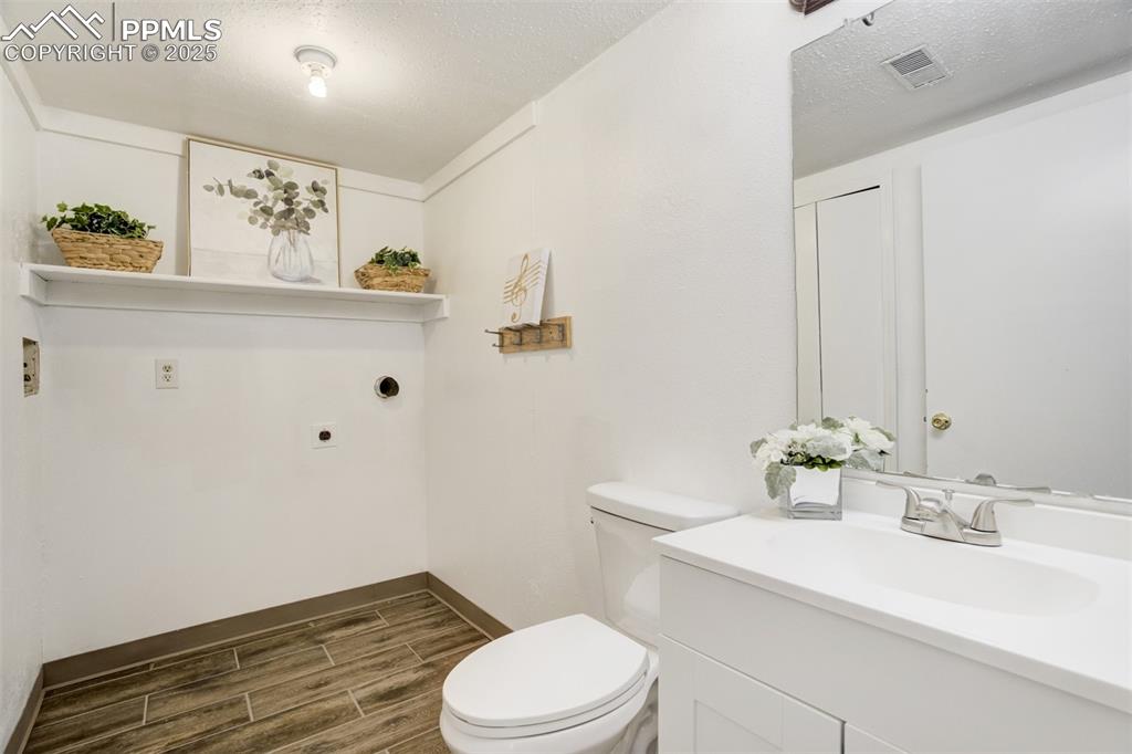 Image 25 of 33: Lower Level 1/2 bath with laundry room