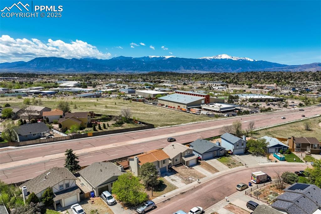 Image 31 of 33: Aerial perspective of suburban area with mountains