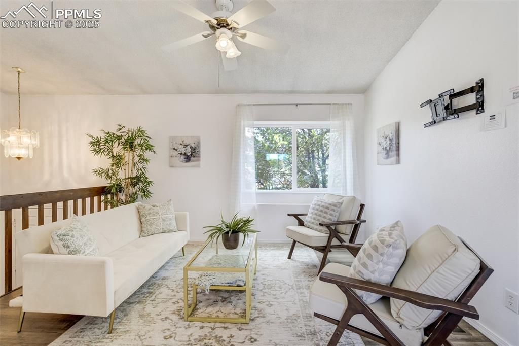 Image 4 of 33: Ceiling fan with front yard views and vaulted ceilings