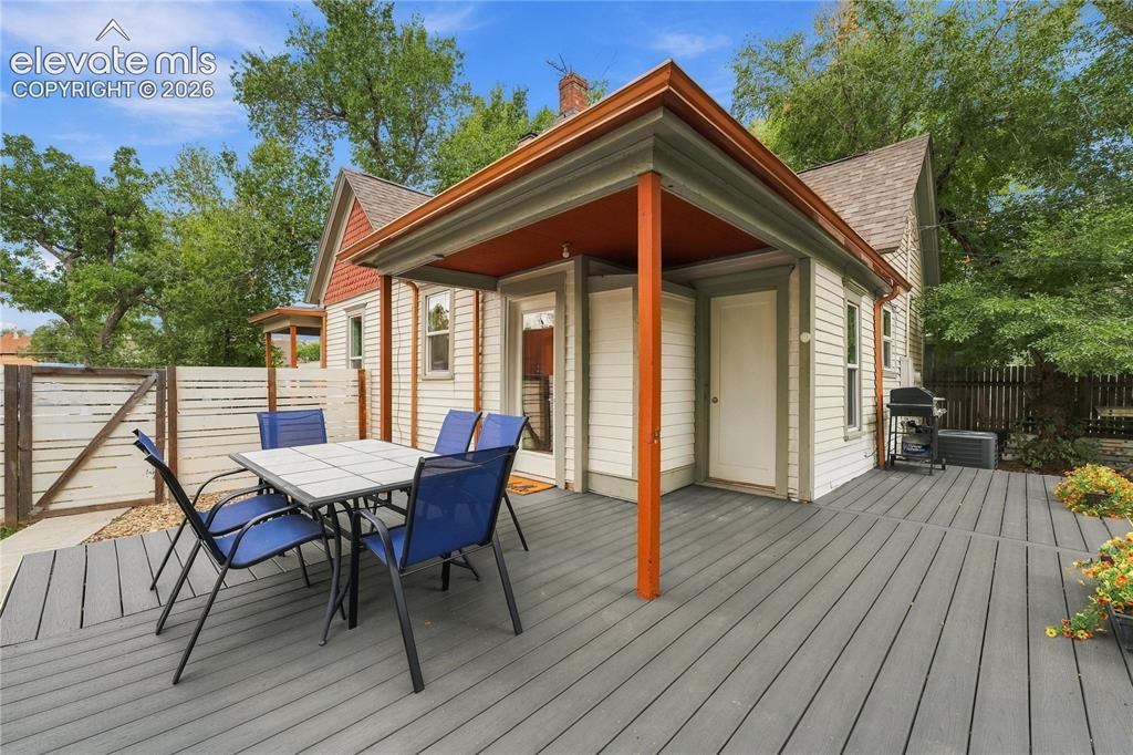 Image 24 of 50: Deck and covered porch on the primary house. 