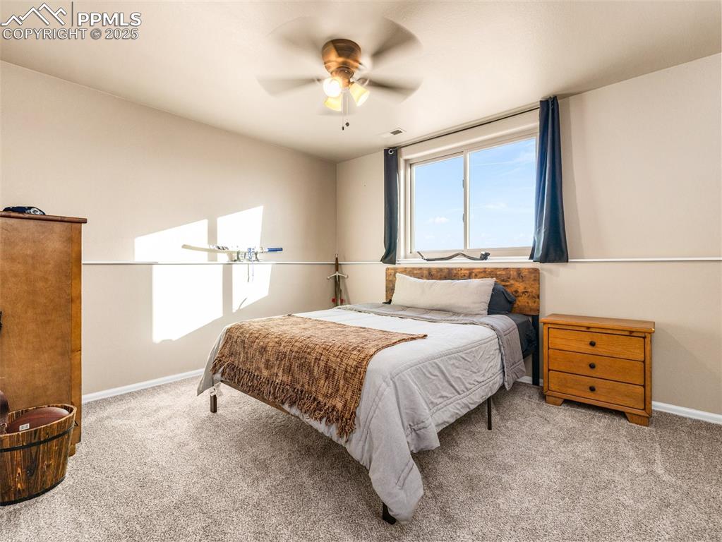 Image 24 of 41: Bedroom featuring a ceiling fan and carpet flooring