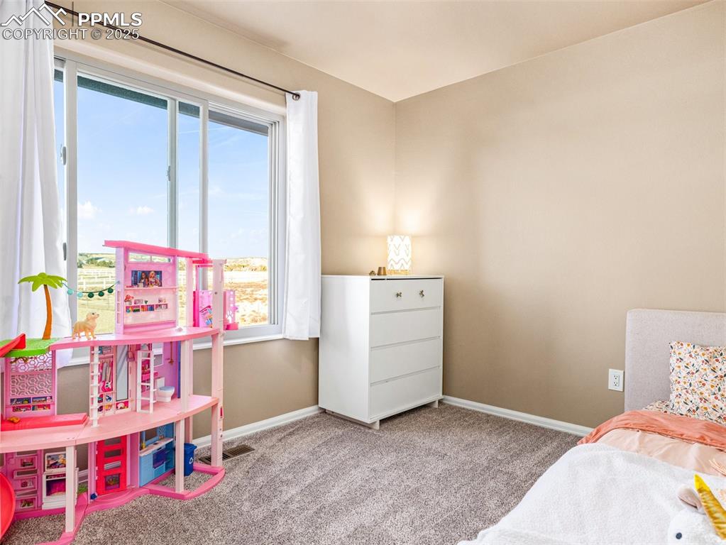Image 29 of 41: Carpeted bedroom with baseboards