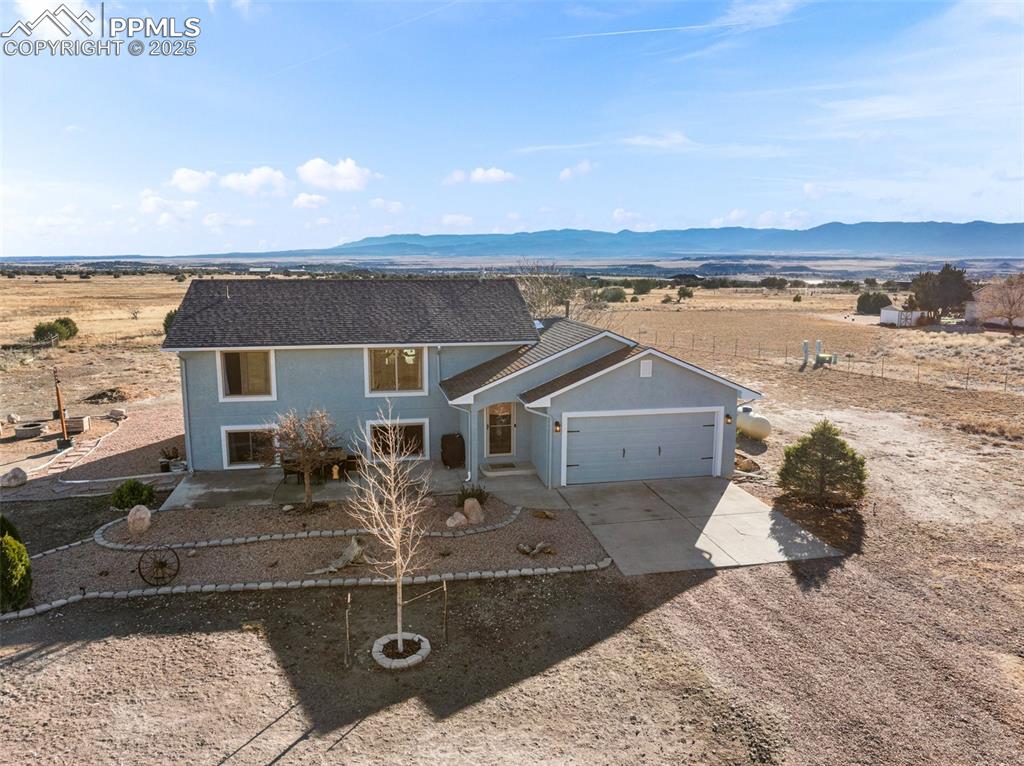 Image 3 of 41: View of front of property featuring concrete driveway, a mountain view, an 