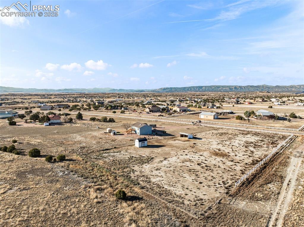 Image 35 of 41: View of rural area with a mountain backdrop and a desert landscape