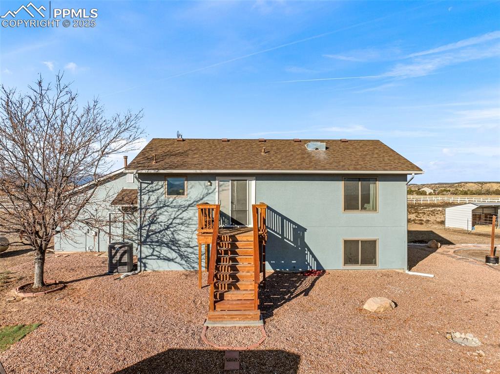 Image 6 of 41: Rear view of house with roof with shingles