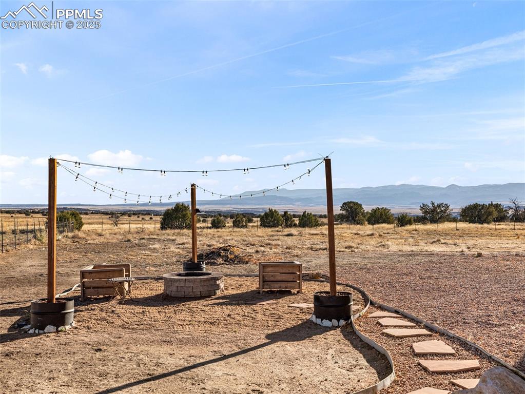 Image 8 of 41: View of yard with a mountain view and a rural view