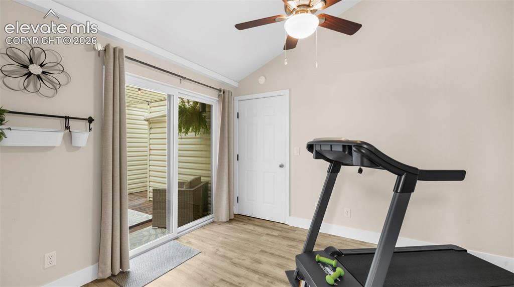 Image 20 of 37: Sliding glass door opening to an outdoor patio with wood-finish flooring