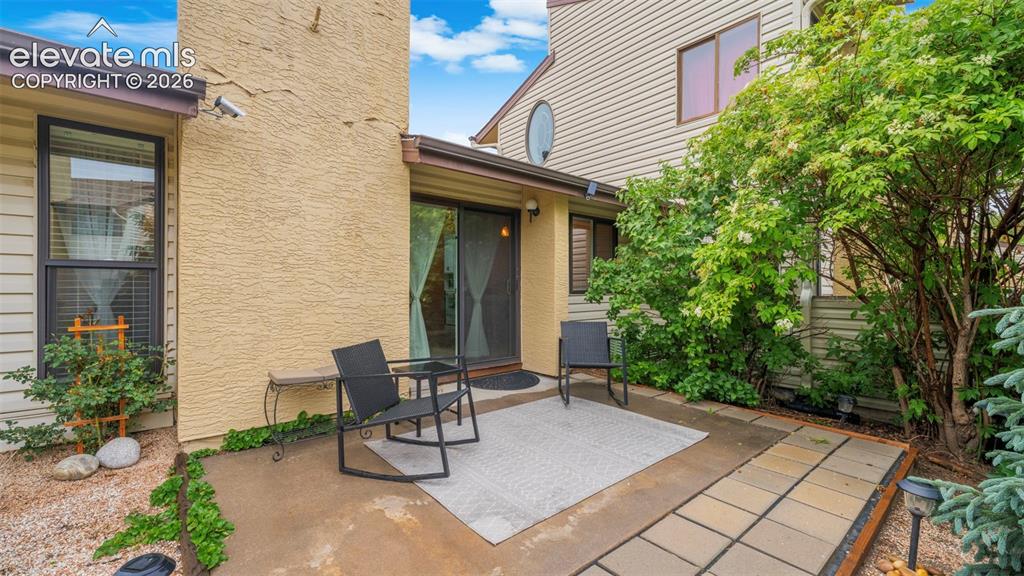 Image 24 of 37: Private patio featuring a sliding glass door entry