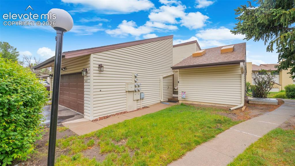 Image 3 of 37: Siding exterior with a brown garage door
