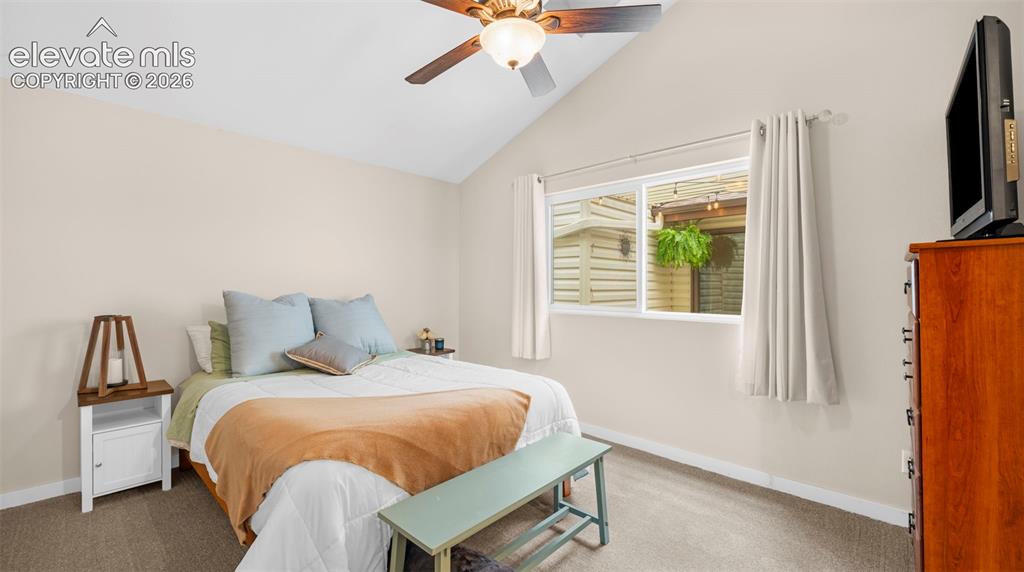 Image 9 of 37: Vaulted ceiling with an overhead fan, single pane window, light-toned walls