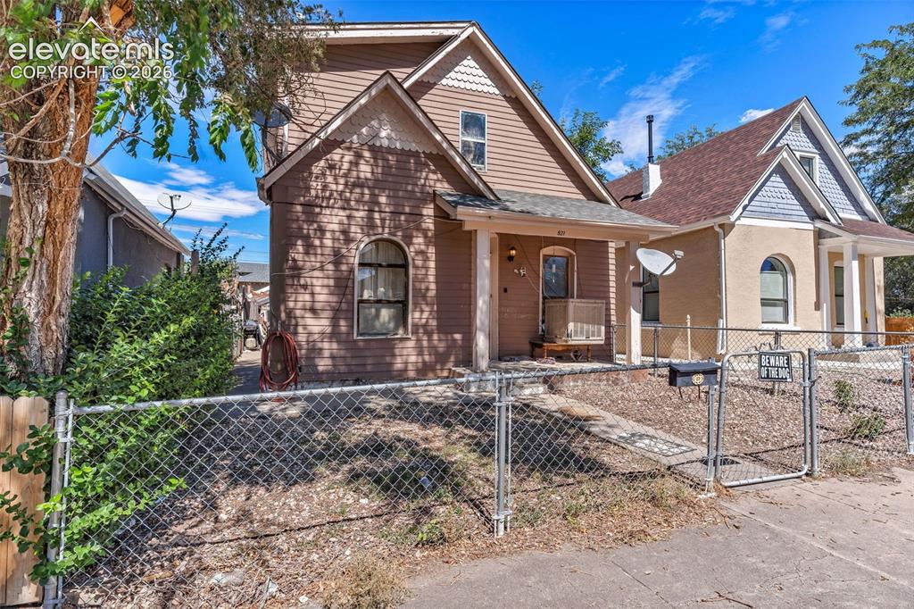 Image 2 of 3: Gabled roofline, siding exterior, covered porch, arched window, and chain-l