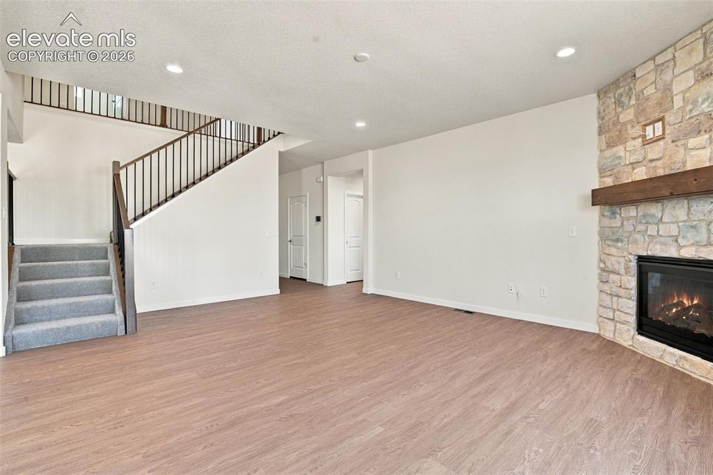 Image 19 of 50: Living area featuring wood-finish flooring, recessed lighting, and a floor-