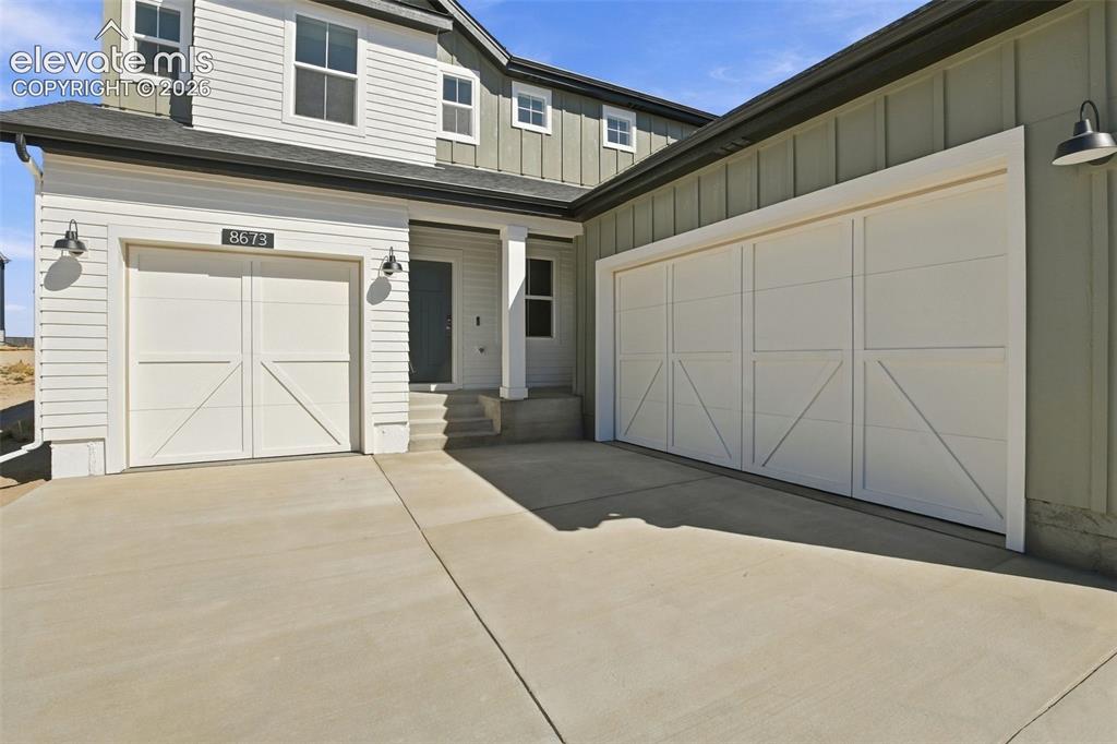 Image 3 of 50: Exterior featuring dual carriage-style garage doors, horizontal and vertica