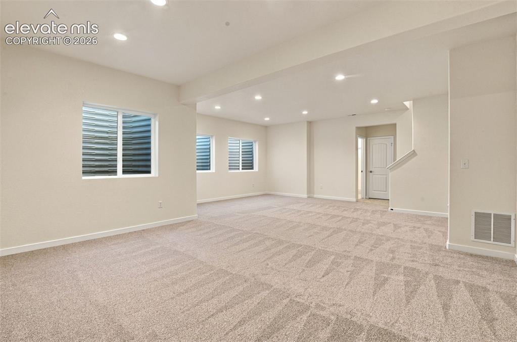 Image 43 of 50: Neutral-toned wall-to-wall carpeting, recessed ceiling lighting, and multip