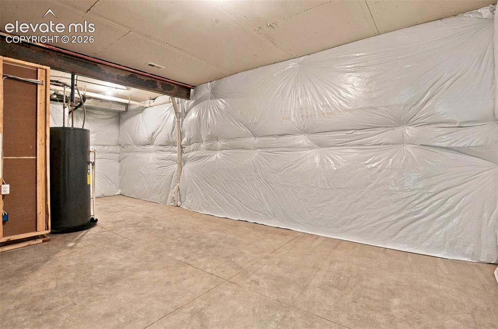 Image 44 of 50: Unfinished lower level space with concrete flooring, reinforced steel struc