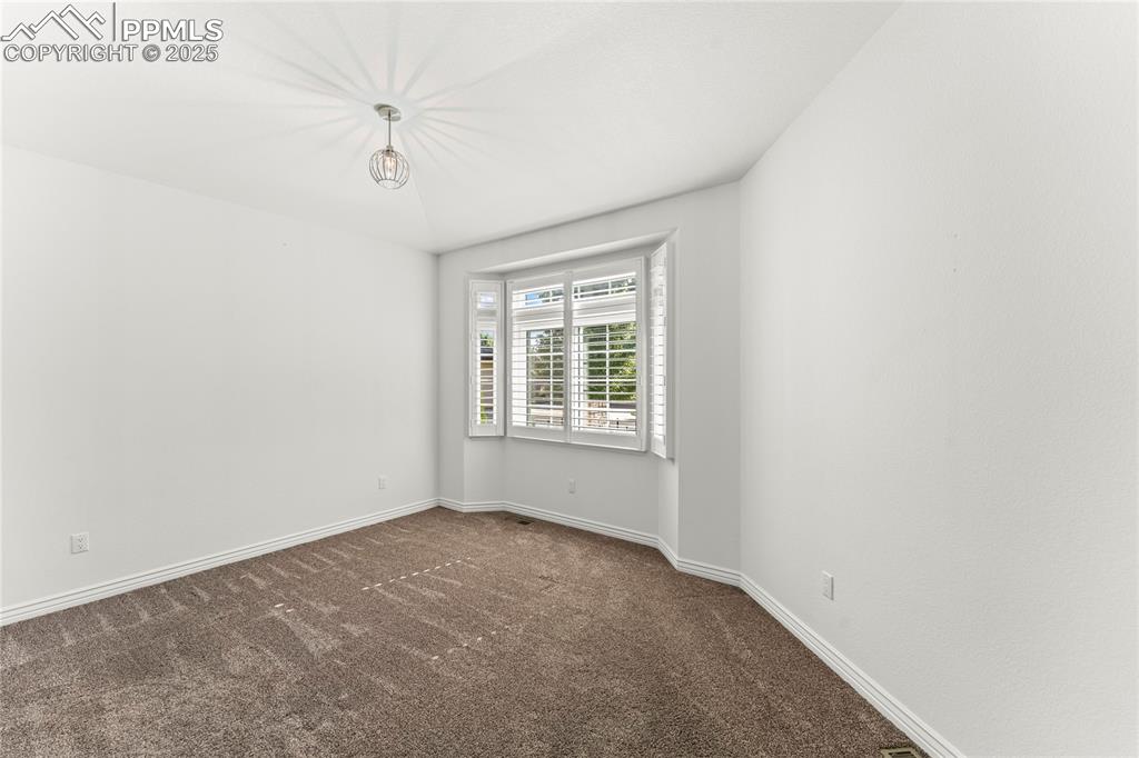 Image 14 of 50: Carpeted bedroom featuring baseboards