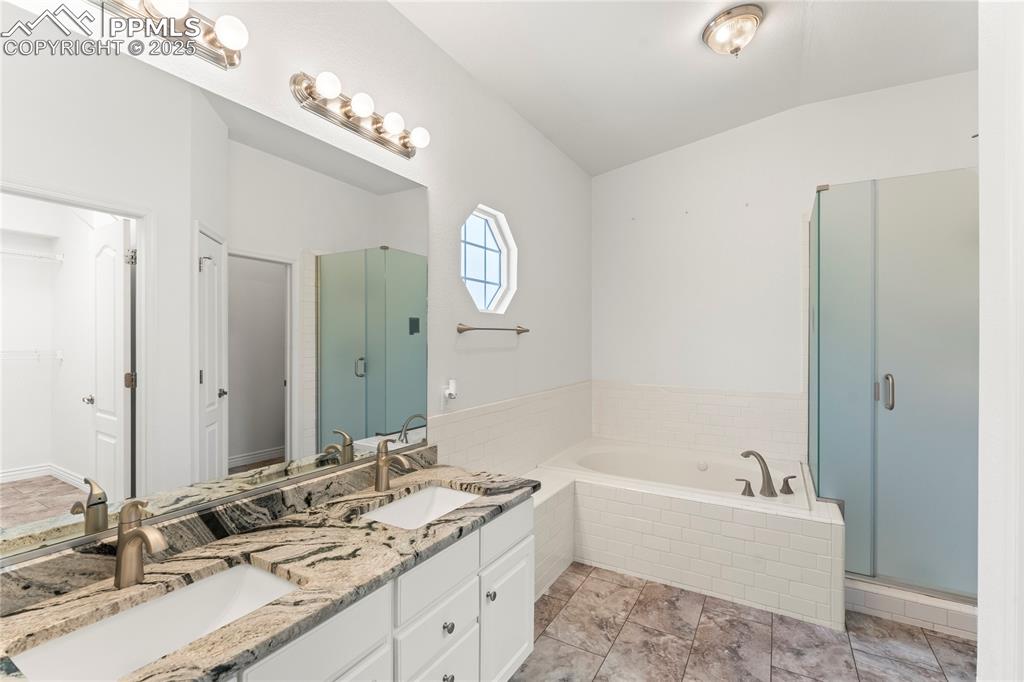 Image 20 of 50: Full bath with a garden tub, double vanity, a stand alone shower, lofted ce