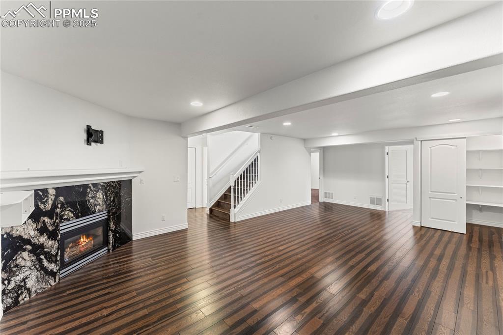Image 31 of 50: Basement living space with fireplace