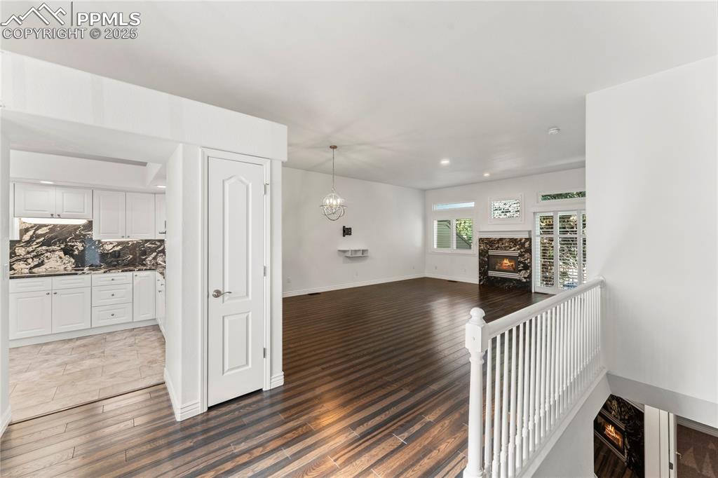 Image 6 of 50: Living room with a view into the kitchen and downstairs