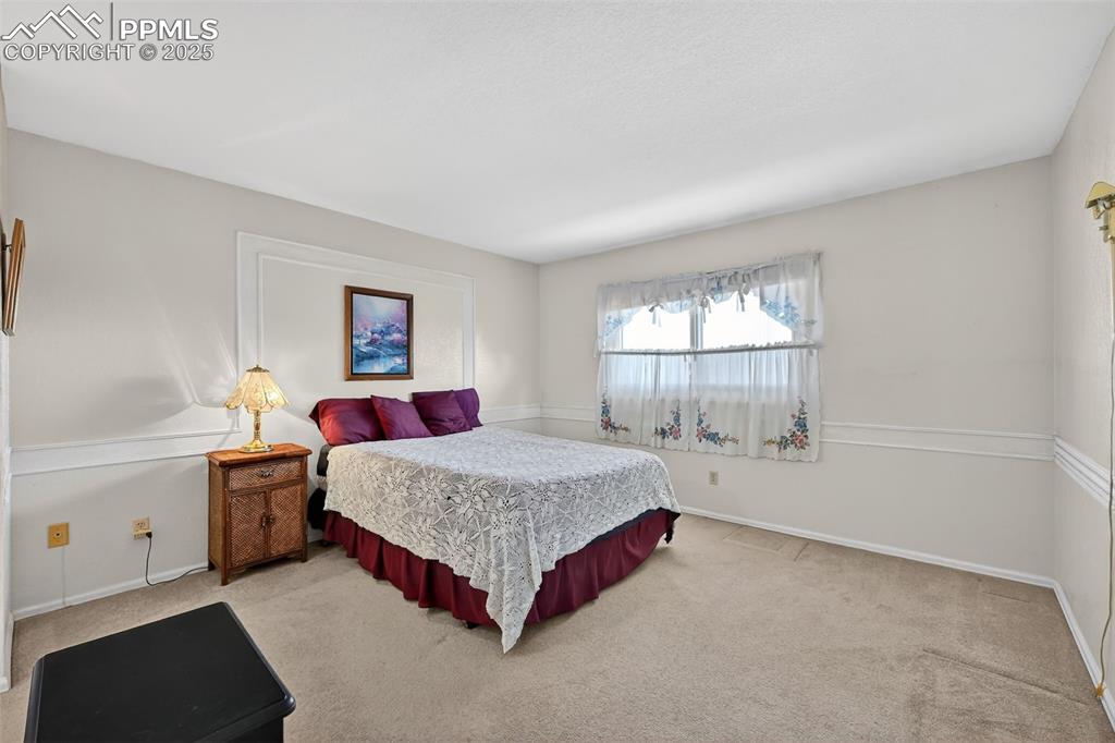 Image 18 of 27: Second upper bedroom has an attached full bath.