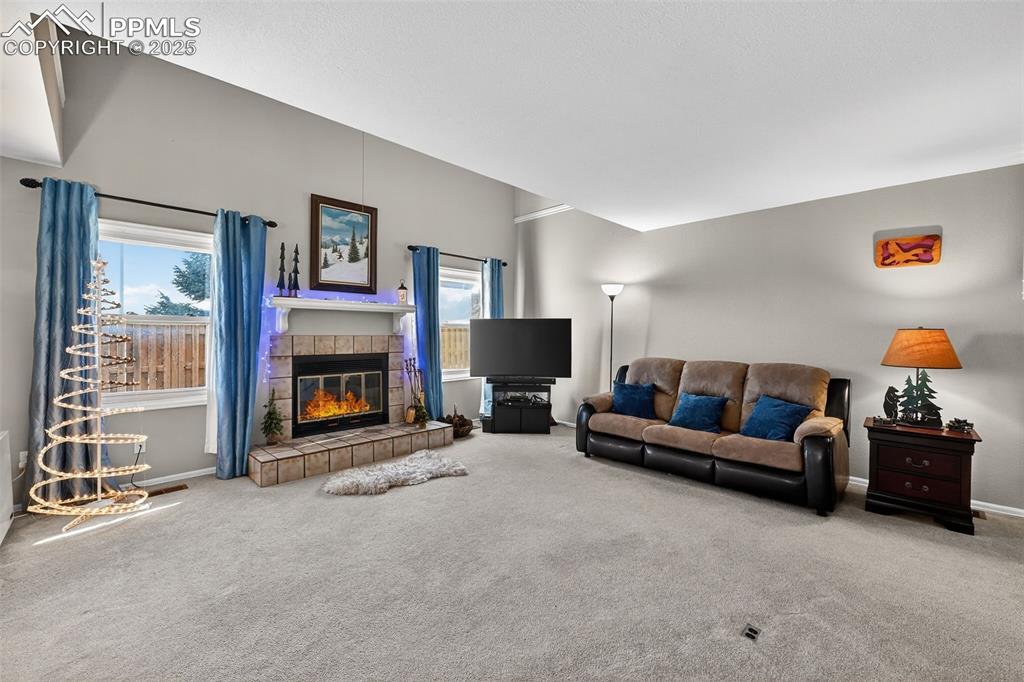 Image 7 of 27: Spacious, open living room with fireplace.