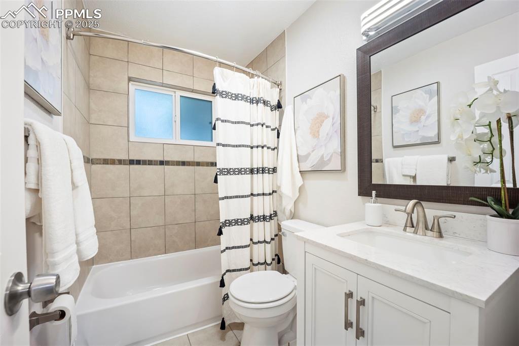 Image 27 of 33: Bathroom (cont) featuring vanity and shower / tub combo with curtain