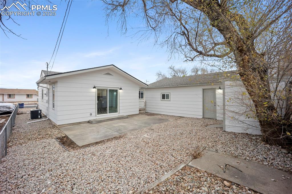 Image 29 of 33: Rear view of fenced property featuring a patio, storage shed
