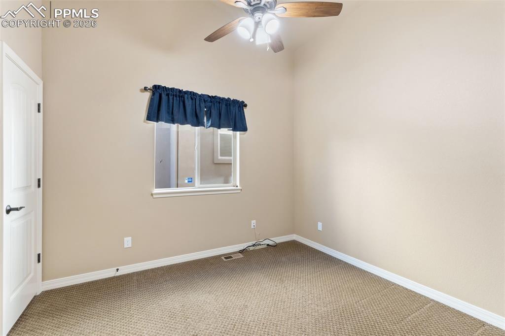 Image 17 of 36: Main Level Bedroom with Ceiling Fan!
