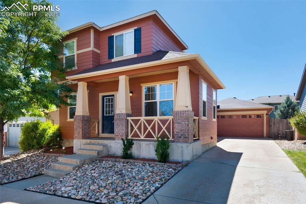 Image 3 of 46: View of front of property with a porch, roof with shingles, a garage, and c