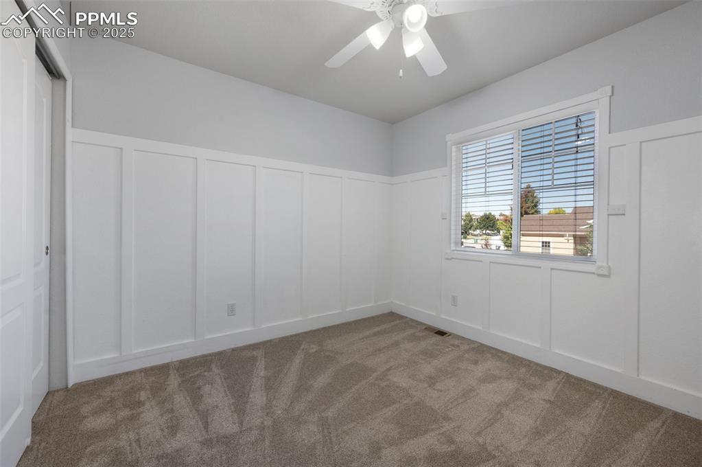 Image 35 of 46: Empty room featuring light colored carpet and a ceiling fan