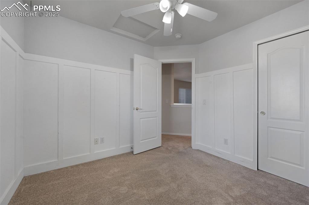 Image 36 of 46: Unfurnished bedroom with light colored carpet, a ceiling fan, and a closet