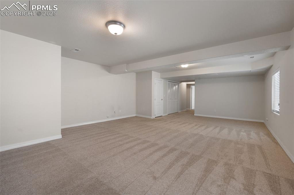 Image 41 of 46: Spare room featuring light colored carpet
