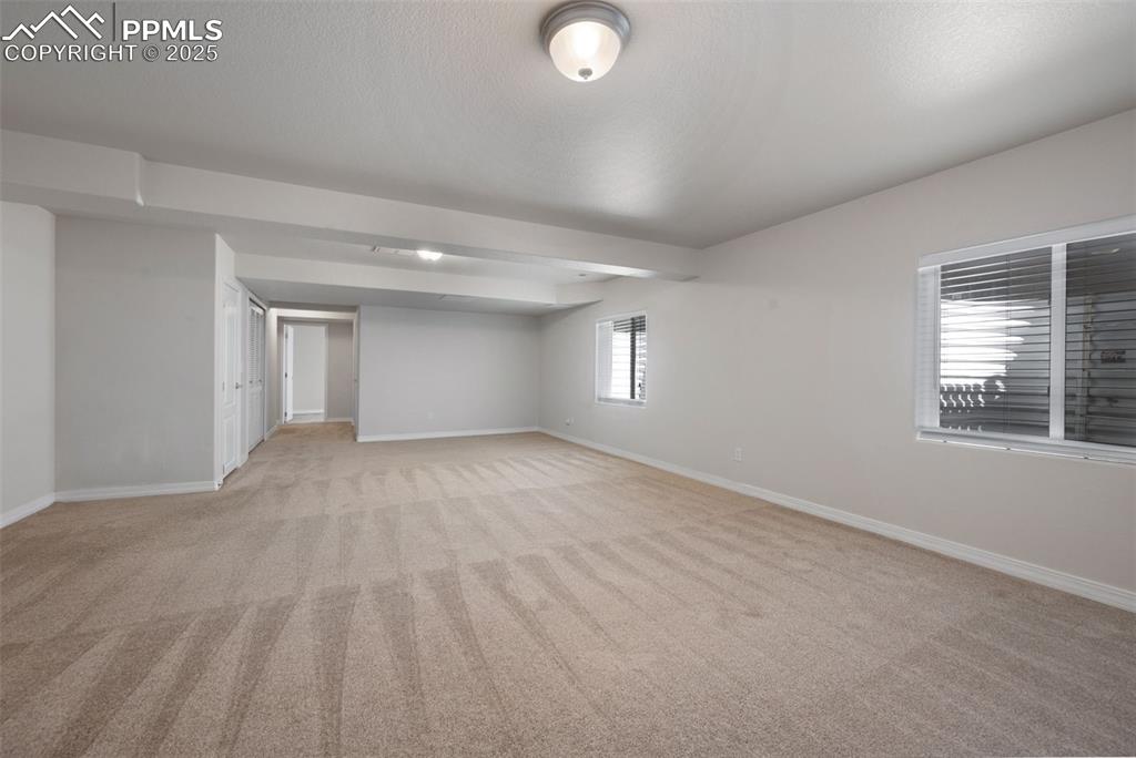 Image 42 of 46: Unfurnished bedroom featuring a spacious closet and light colored carpet