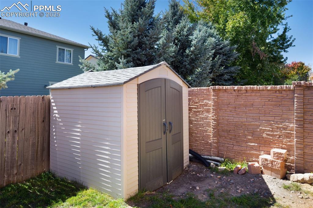 Image 48 of 48: View of shed with a fenced backyard
