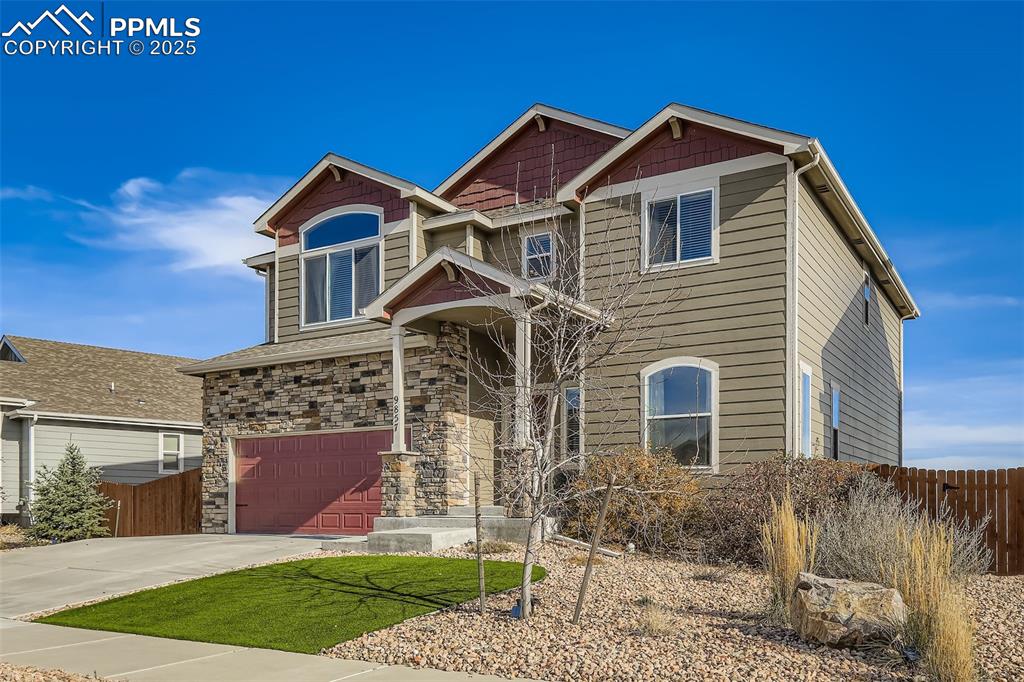 Image 2 of 35: Craftsman inspired home with an attached garage, concrete driveway, and sto