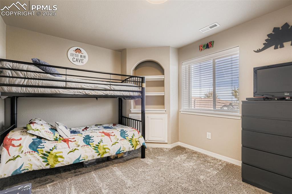 Image 23 of 35: Carpeted bedroom featuring baseboards
