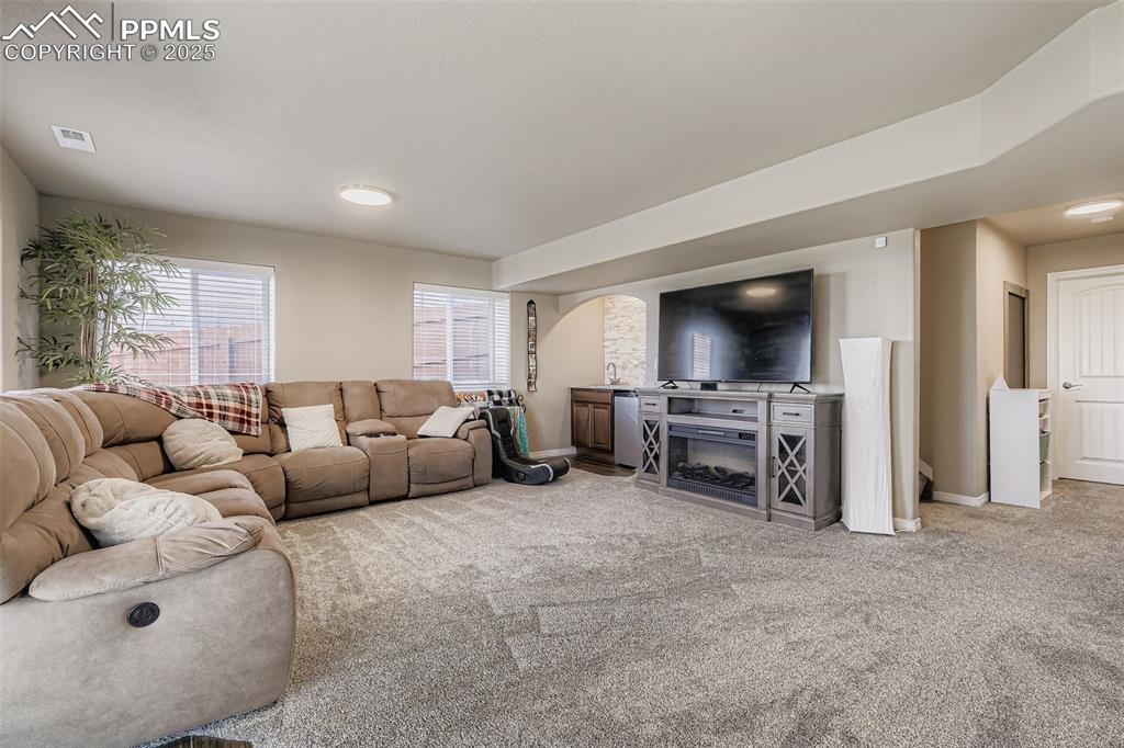 Image 26 of 35: Living room featuring light carpet and baseboards