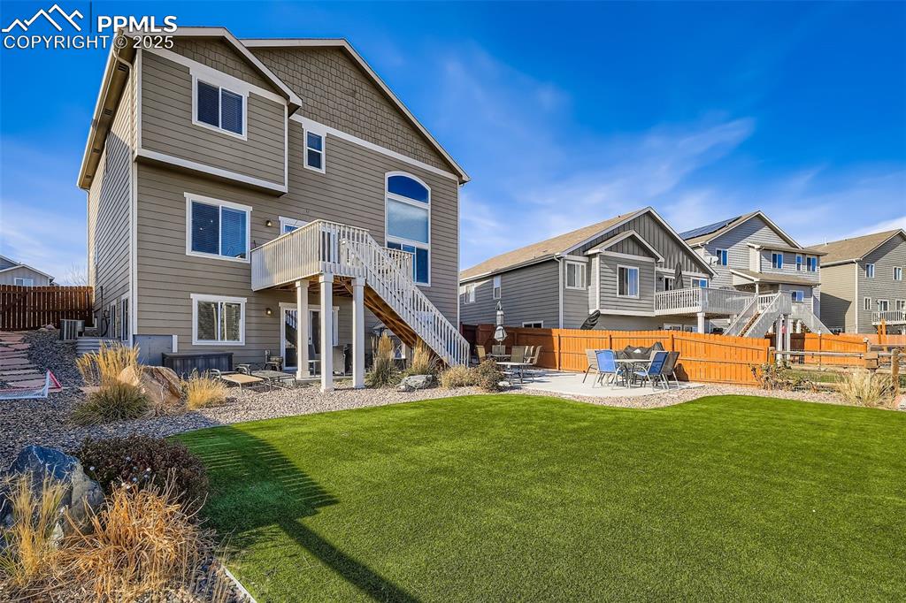 Image 29 of 35: Rear view of property with a patio area, stairway, and a deck